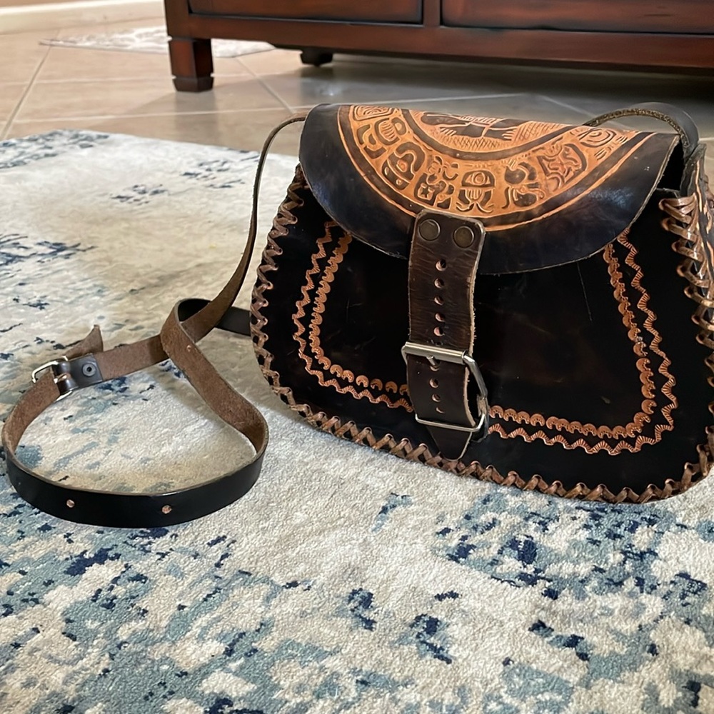 Gently used handmade in Mexico cross body bohemian leather purse.